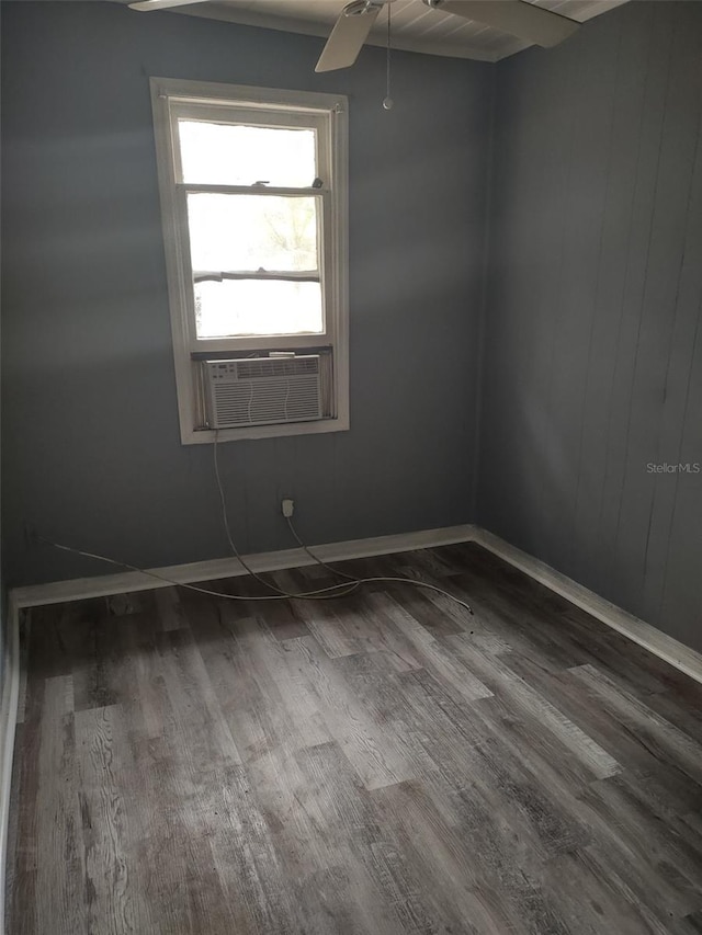 empty room featuring wood-type flooring, ceiling fan, cooling unit, and beam ceiling