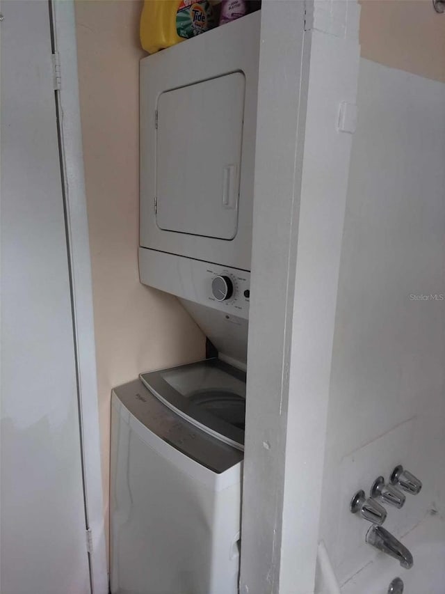 laundry area with stacked washer / drying machine