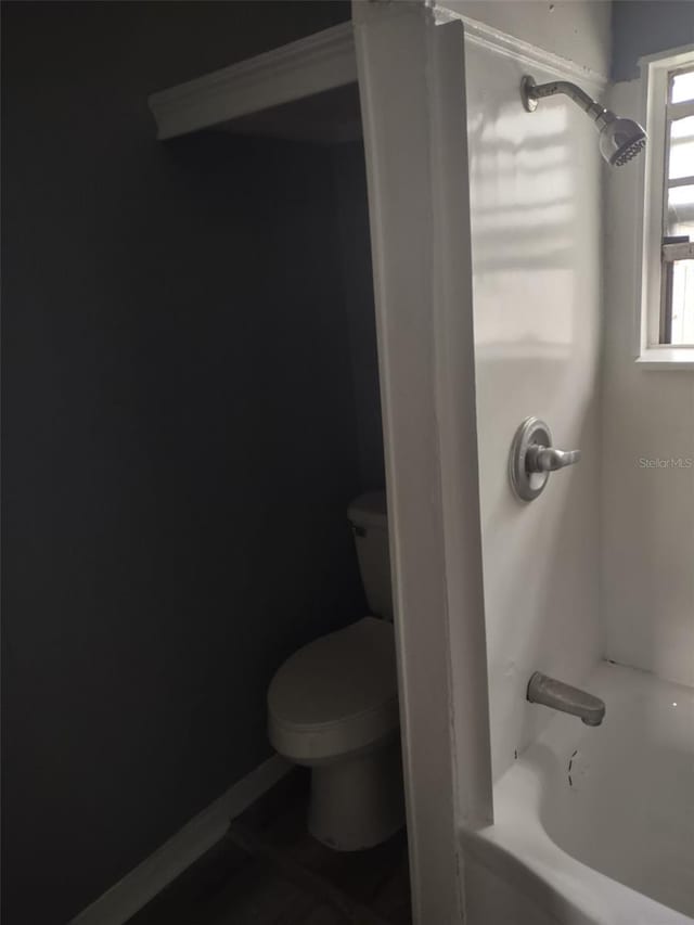 bathroom with toilet and shower / washtub combination