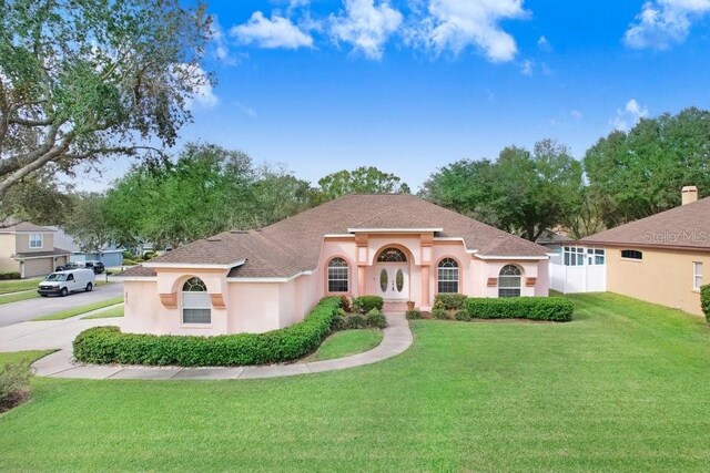 mediterranean / spanish-style home featuring a front lawn