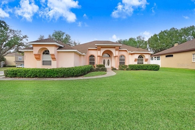 mediterranean / spanish-style house with a front yard