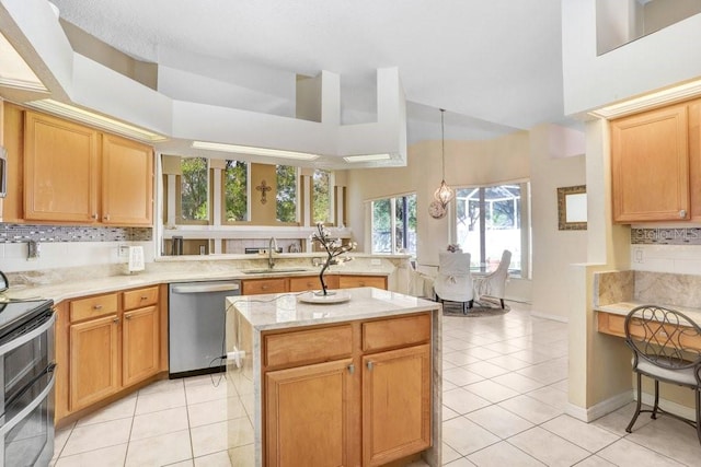 kitchen with sink, light tile patterned floors, stainless steel appliances, and tasteful backsplash