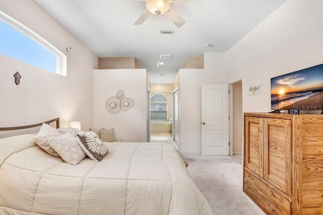 carpeted bedroom featuring ceiling fan and ensuite bathroom