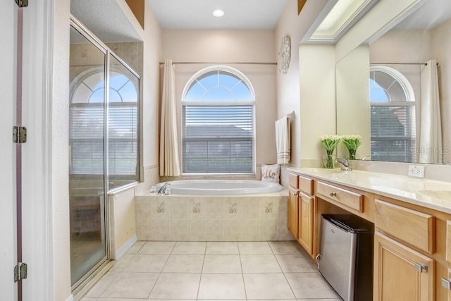 bathroom featuring tile patterned floors, vanity, and shower with separate bathtub