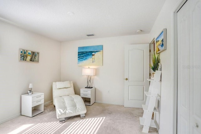 living area featuring light colored carpet