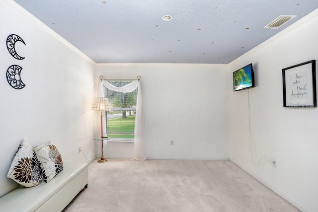 carpeted empty room featuring crown molding