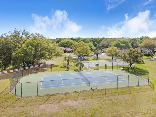 view of sport court featuring a yard