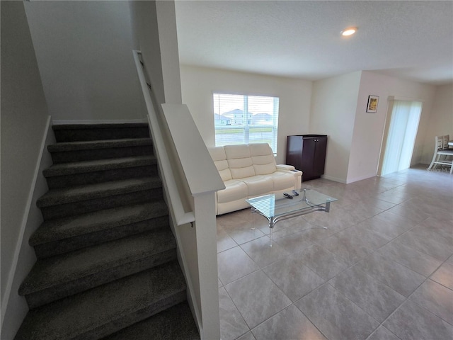 unfurnished living room with light tile patterned flooring