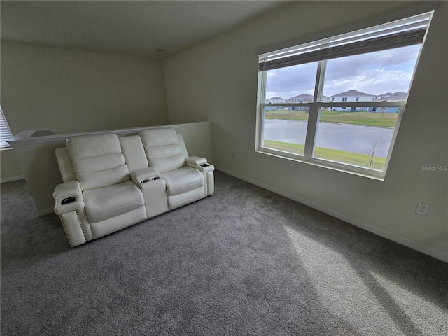 unfurnished living room featuring a water view and dark carpet