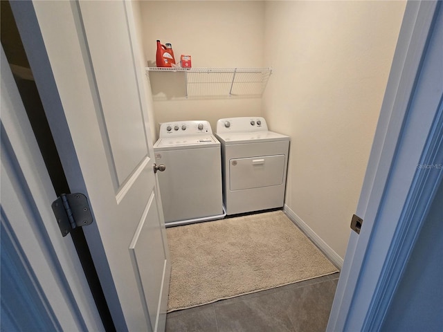 laundry room with washer and dryer and dark carpet