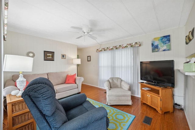 living room with wood-type flooring and ceiling fan