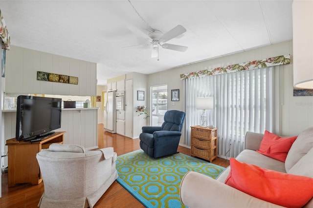 living room featuring ceiling fan and light wood-type flooring