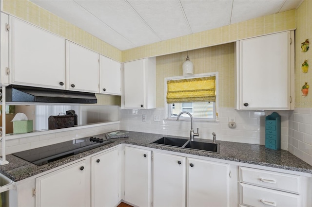 kitchen with white cabinetry, sink, tasteful backsplash, dark stone countertops, and black electric stovetop