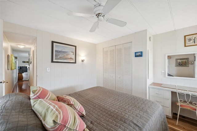 bedroom with ceiling fan, a closet, and wood-type flooring