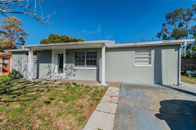 single story home with fence and stucco siding