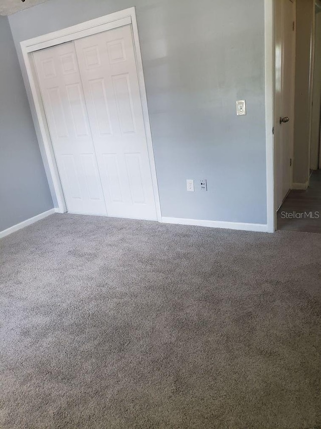 unfurnished bedroom with carpet and a closet