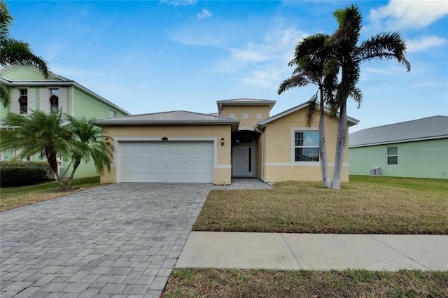 view of front of property featuring a garage and a front lawn