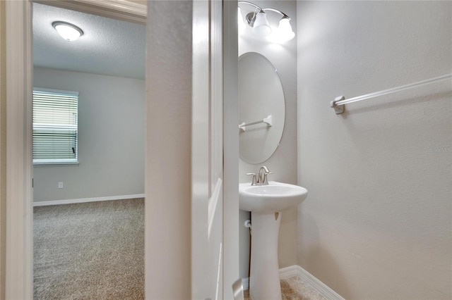 bathroom with sink and a textured ceiling