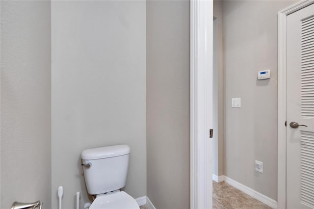 bathroom with tile patterned flooring and toilet