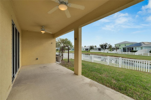 view of patio / terrace featuring ceiling fan and a water view