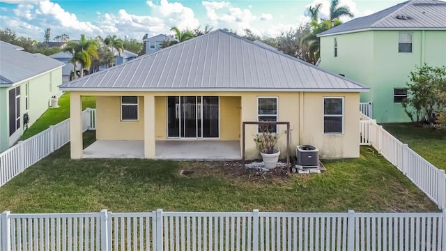 back of property with cooling unit, a patio area, and a yard