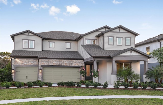 craftsman-style home featuring a front lawn and a garage