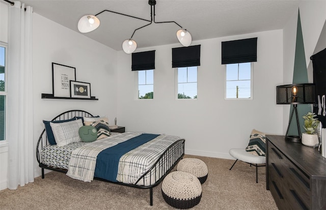 bedroom featuring light colored carpet