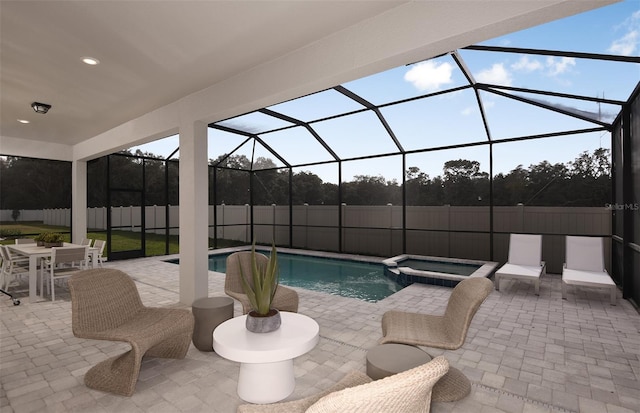 view of pool with a lanai, an in ground hot tub, and a patio