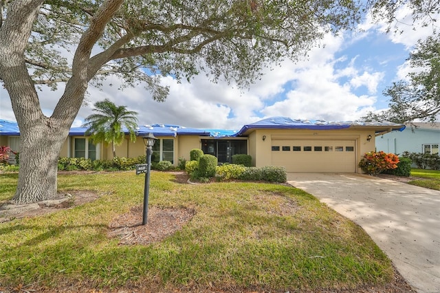 ranch-style home with a garage and a front lawn