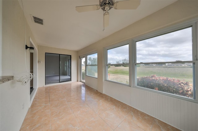 unfurnished sunroom with ceiling fan