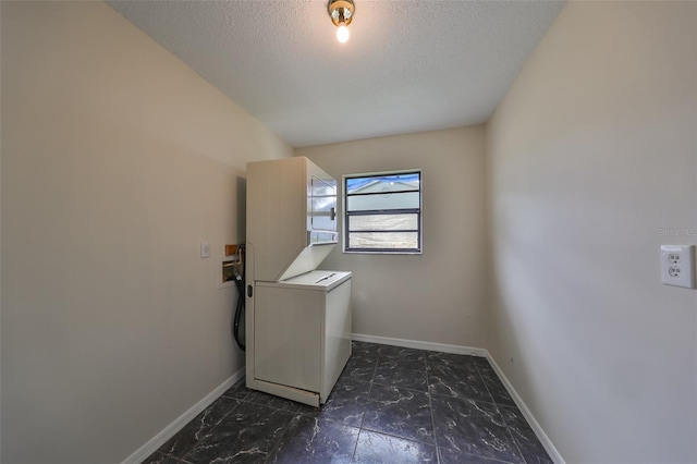 laundry room featuring stacked washer and clothes dryer and a textured ceiling