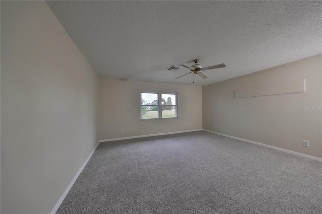 carpeted spare room with ceiling fan and a textured ceiling