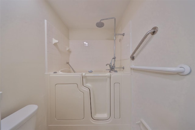 bathroom featuring a washtub and toilet