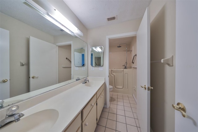 full bathroom featuring vanity, shower / washtub combination, tile patterned flooring, toilet, and a textured ceiling