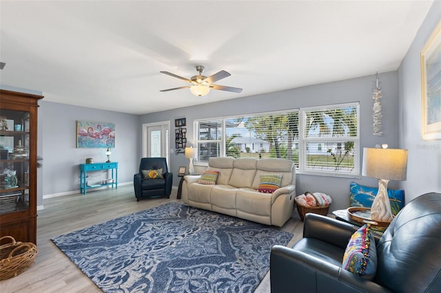 living room with ceiling fan and hardwood / wood-style flooring