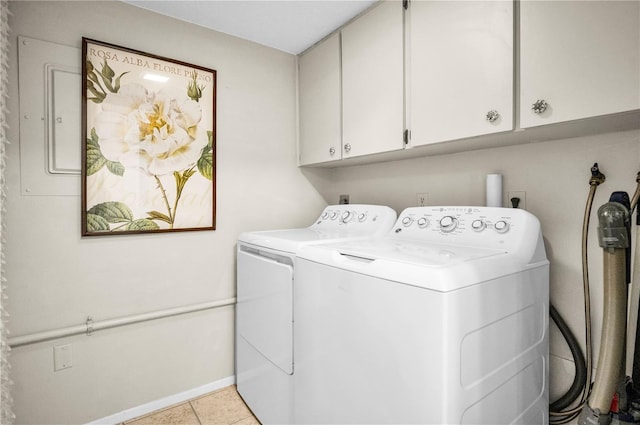 laundry room featuring cabinets, separate washer and dryer, and light tile patterned floors