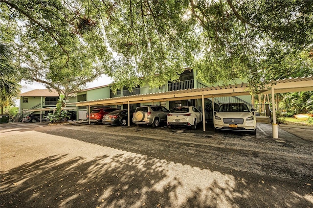 view of parking / parking lot featuring a carport