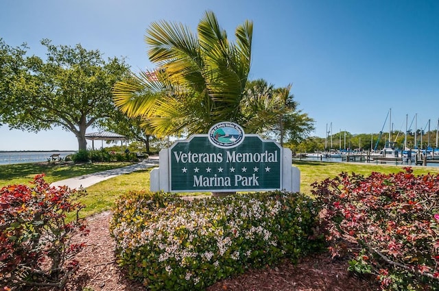 community / neighborhood sign featuring a water view