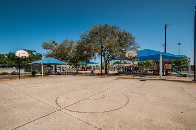 view of sport court featuring a playground and a gazebo