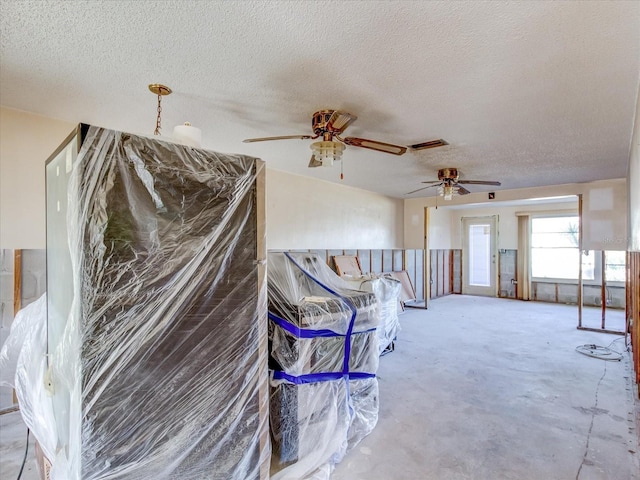 interior space with concrete flooring, a textured ceiling, and ceiling fan