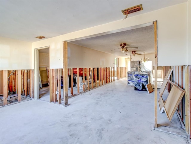 miscellaneous room featuring ceiling fan and concrete flooring