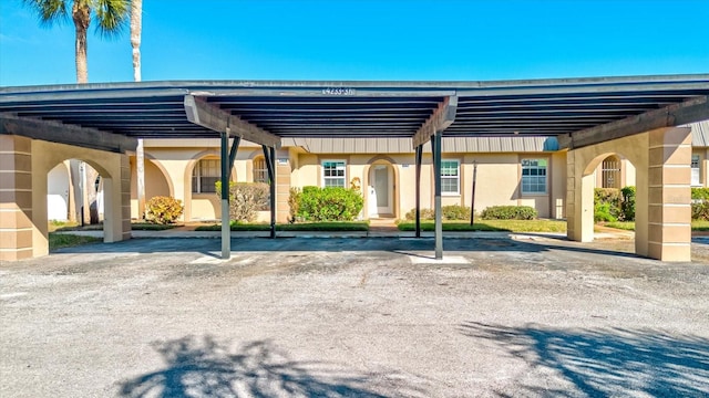 view of vehicle parking with a carport