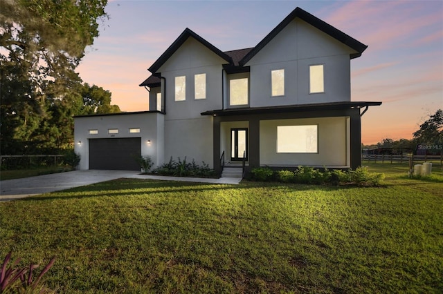 view of front of home featuring a lawn and a garage