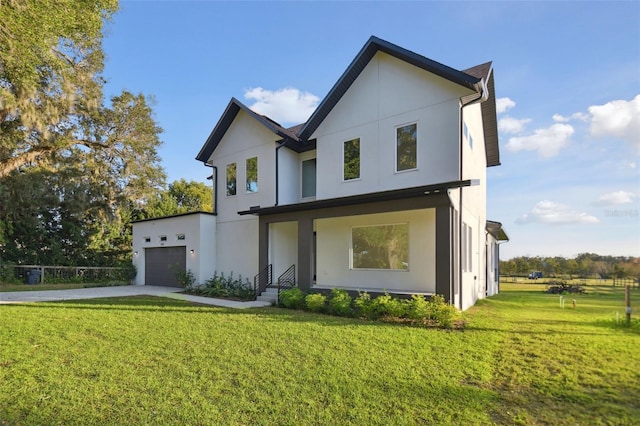 rear view of property with a lawn and a garage