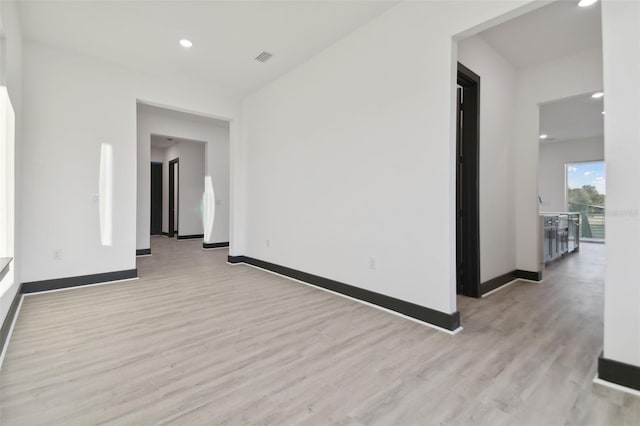 unfurnished room featuring light hardwood / wood-style floors