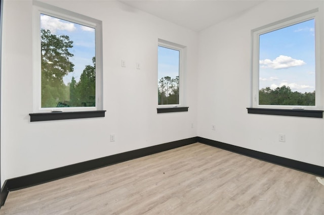 spare room featuring light hardwood / wood-style floors