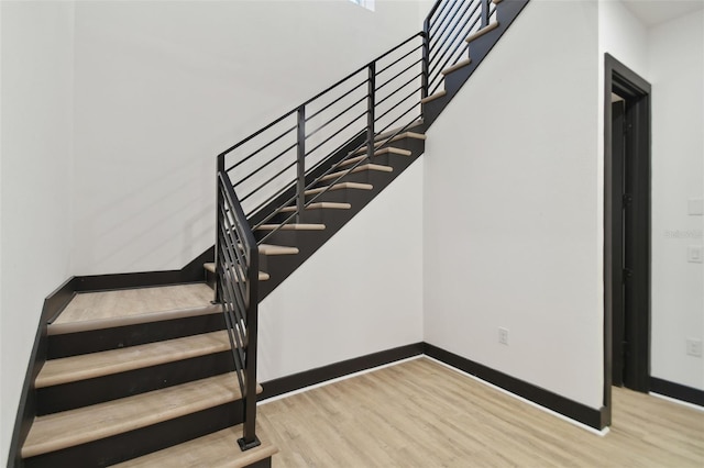 stairs featuring hardwood / wood-style floors