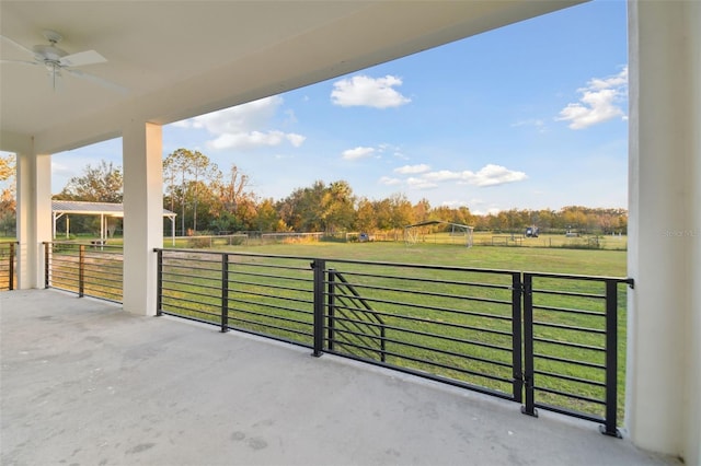 view of patio with ceiling fan and a rural view