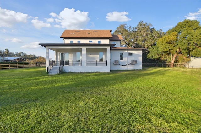 rear view of property with a yard