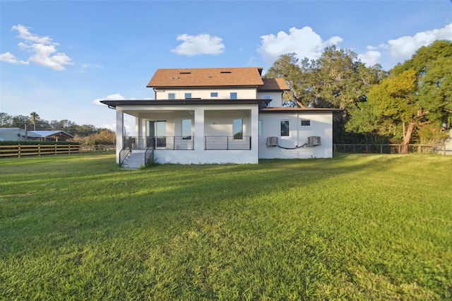 rear view of property with a lawn